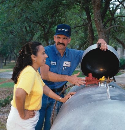 Repair Man helping woman with propane tank